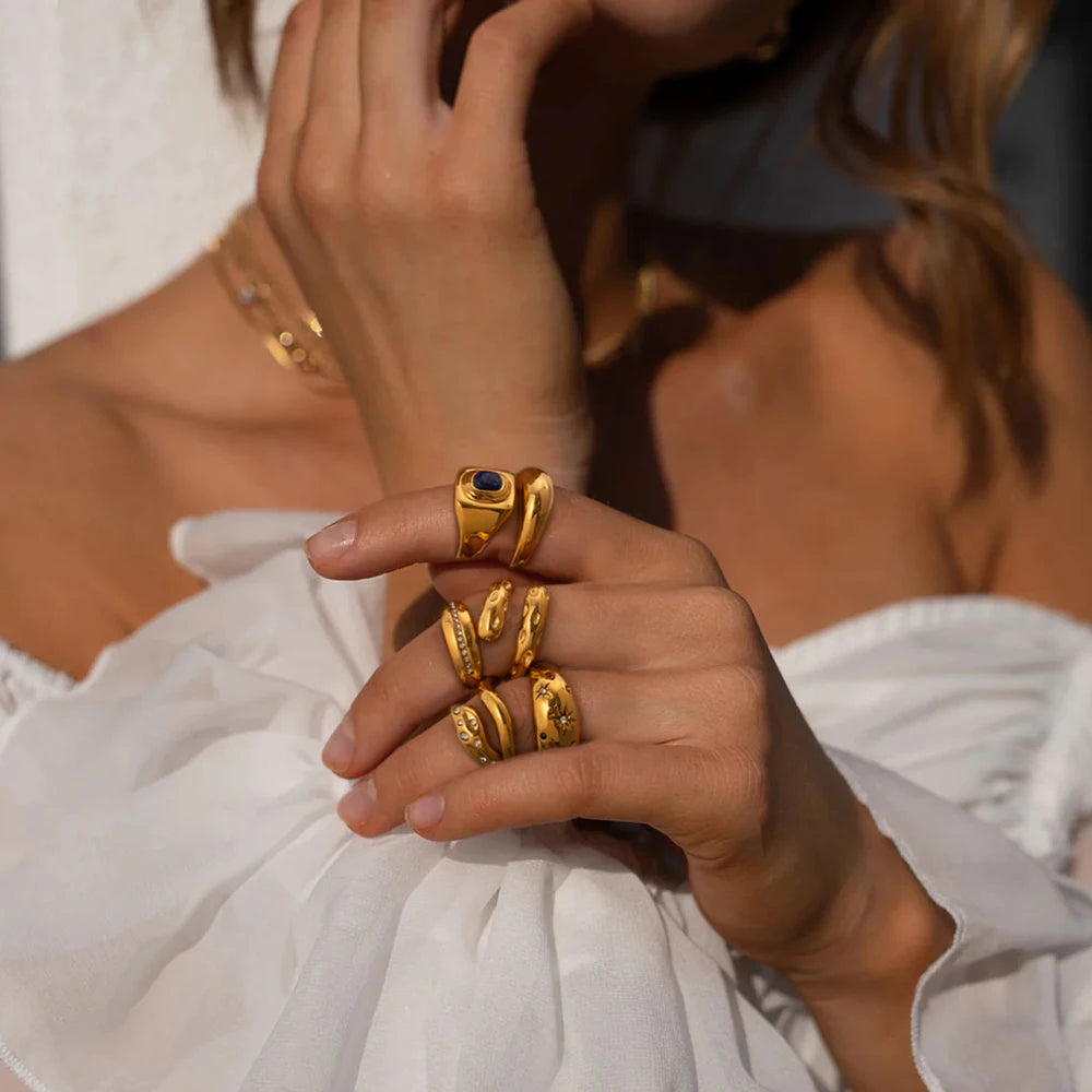 Femme colliers bagues mains pierres précieuses or cheveux chemise blanche